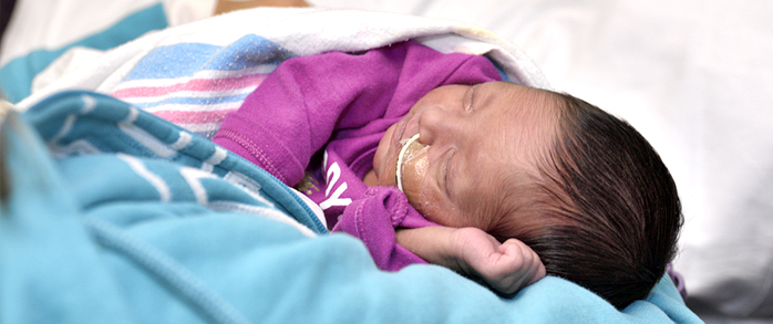 A high-risk infant being cared for