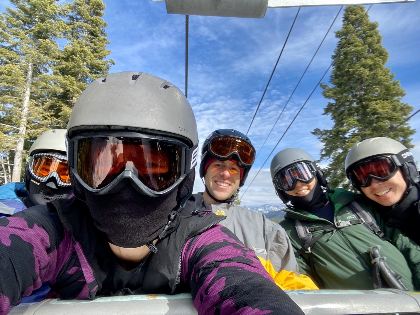 five resident taking selfi while riding gondola